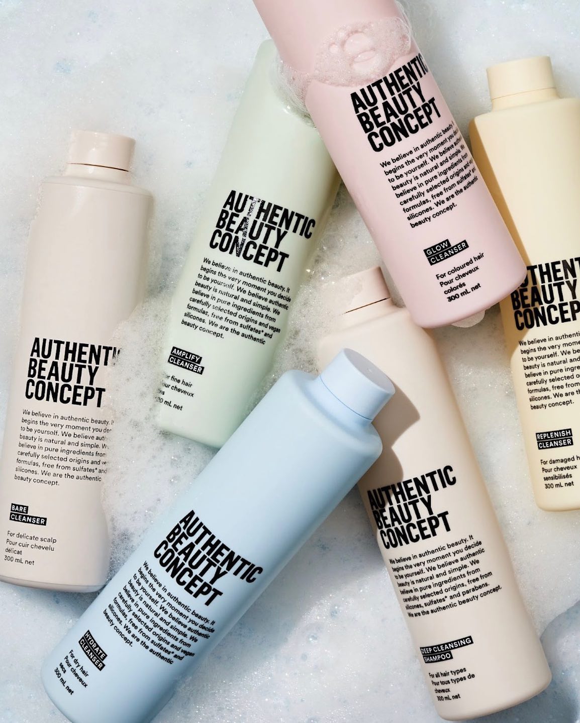Authentic Beauty Concept Products in Soapy Water - Featuring One Product from Each Collection: Hydrate, Amplify, Replenish, and Indulge