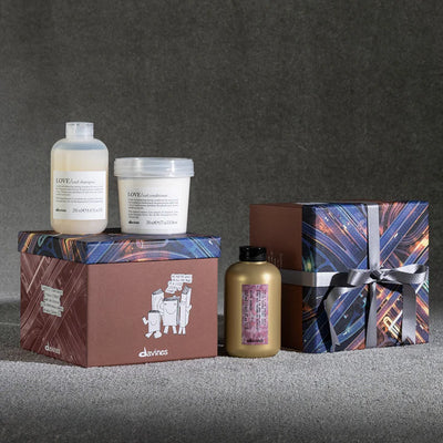 Davines Love Curl More Inside Gift Set featuring shampoo, conditioner, and curl building serum in decorative boxes.
