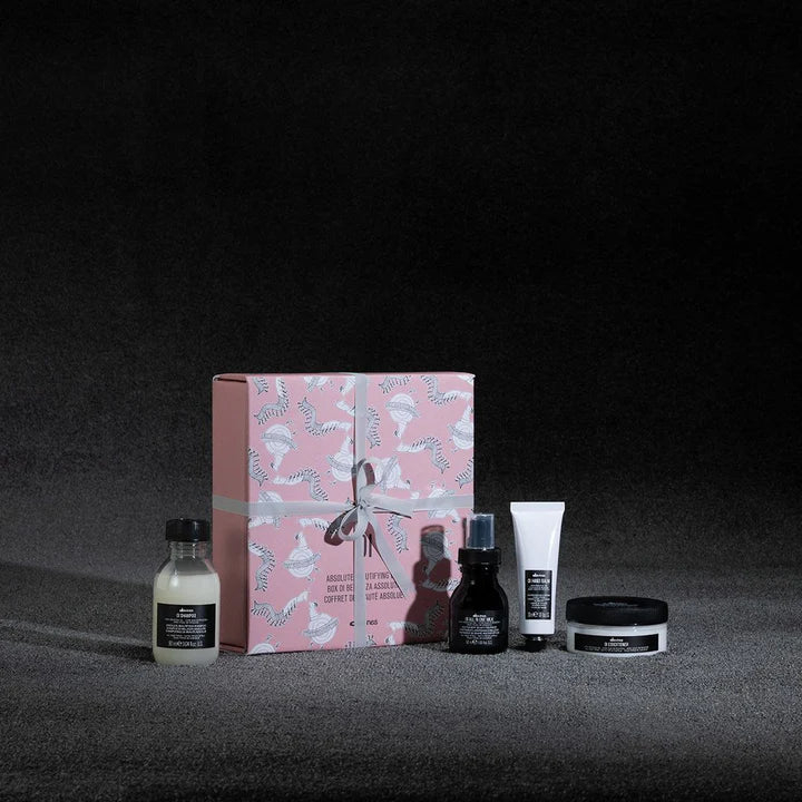 Oi Travel Gift Set featuring shampoo, conditioner, leave-in treatment, and hand balm in a decorative box.