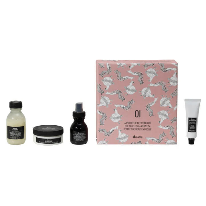 Davines Oi Travel Gift Set featuring shampoo, conditioner, leave-in milk, and hand balm in a decorative box.