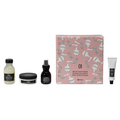 Davines Oi Travel Gift Set featuring shampoo, conditioner, leave-in milk, and hand balm in a decorative box.