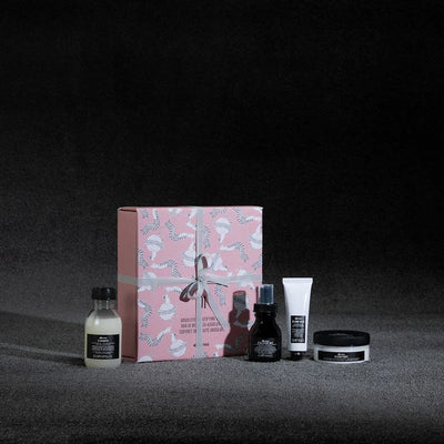 Oi Travel Gift Set featuring shampoo, conditioner, leave-in treatment, and hand balm in a decorative box.
