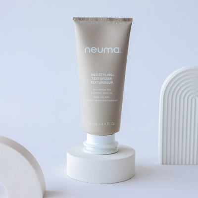 Neuma Neu Styling Texturizer crème in a tube on a display, offering flexible hold and natural shine for textured hairstyles.