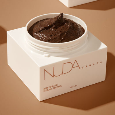 Luxurious body exfoliant in white jar with creamy coffee texture, designed for smoother and healthier skin.