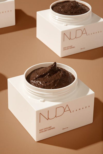 Nuda Canada Body Exfoliant in a white jar, showcasing rich exfoliating texture for smooth, glowing skin.