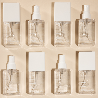 Set of eight bottles of Face Tan Water, a clear tanning mist for a natural glow and healthy complexion.