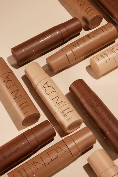 Various self tanning mousse bottles in different shades for customizable tanning results, displayed on a neutral background.