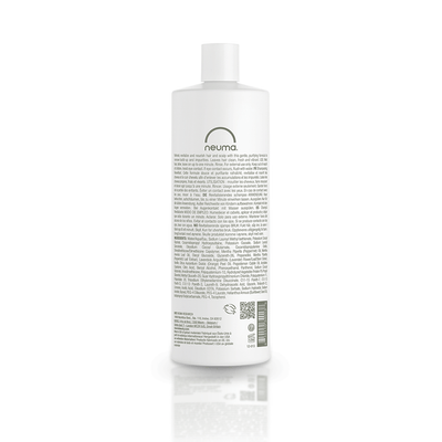 Back view of Neuma Re Neu Clarifying Shampoo bottle showcasing product information and ingredients.