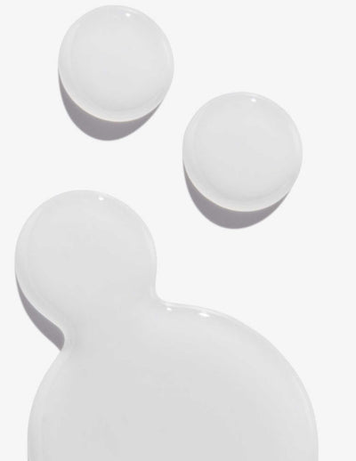 Clear gel texture of a hair treatment, showcasing smoothness and light reflection.