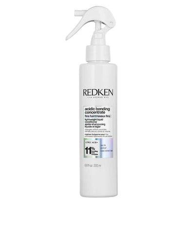 Redken Acidic Bonding Concentrate Lightweight Liquid Conditioner in a spray bottle for strengthening and nourishing hair.