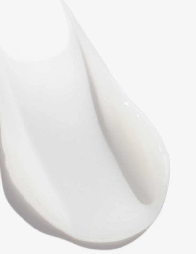 Close-up of Redken Acidic Perfecting Concentrate Leave-in Treatment, showcasing its creamy, smooth texture.