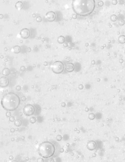 Bubbles on a white background, representing a refreshing and cleansing texture for hair treatments.
