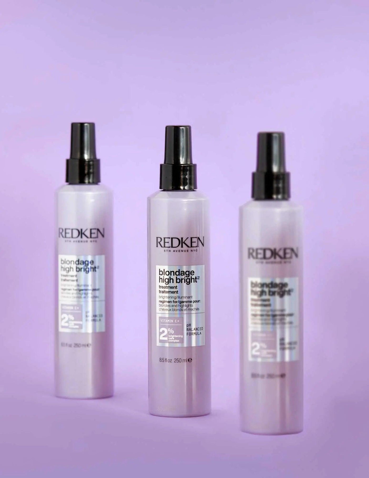 Redken Blondage High Bright Treatment bottles on a pastel purple background, ideal for enhancing blonde hair vibrancy.