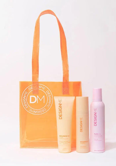 BOUNCE.ME Curl Glow & Go Kit with curl balm and styling products in an orange tote bag. Perfect for wavy, curly, and coily hair types.
