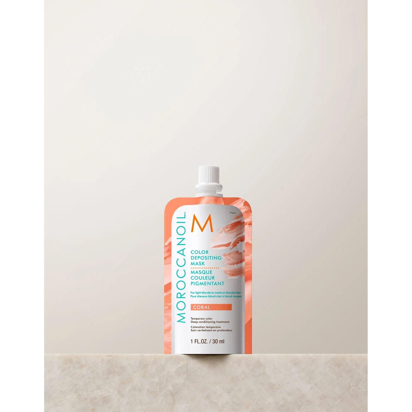 Moroccanoil Color Depositing Mask 30ml in Coral packaging, designed to enhance hair color and shine with argan oil.