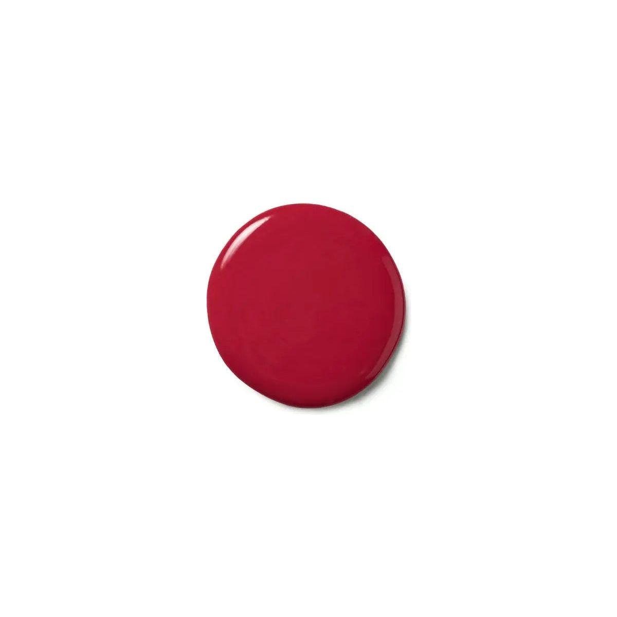 Deep red color deposit mask on a surface, showcasing its glossy texture for vibrant hair rejuvenation.