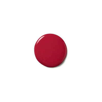 Deep red color deposit mask on a surface, showcasing its glossy texture for vibrant hair rejuvenation.