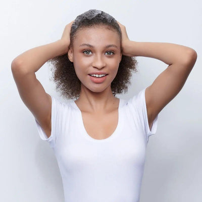 Model applying Moroccanoil Curl Control Mousse for defined, frizz-free curls and natural texture.
