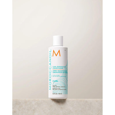 Moroccanoil Curl Enhancing Conditioner bottle on a light background, designed to nourish and define curls.