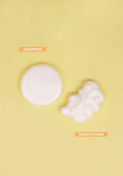 Curl shampoo and conditioner swatches on a yellow background, showcasing nourishing formulas for waves and curls.