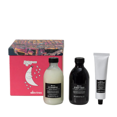 Davines OI Lifestyle Gift Set featuring OI Shampoo, OI Body Wash, and OI Hand Balm in a decorative box.