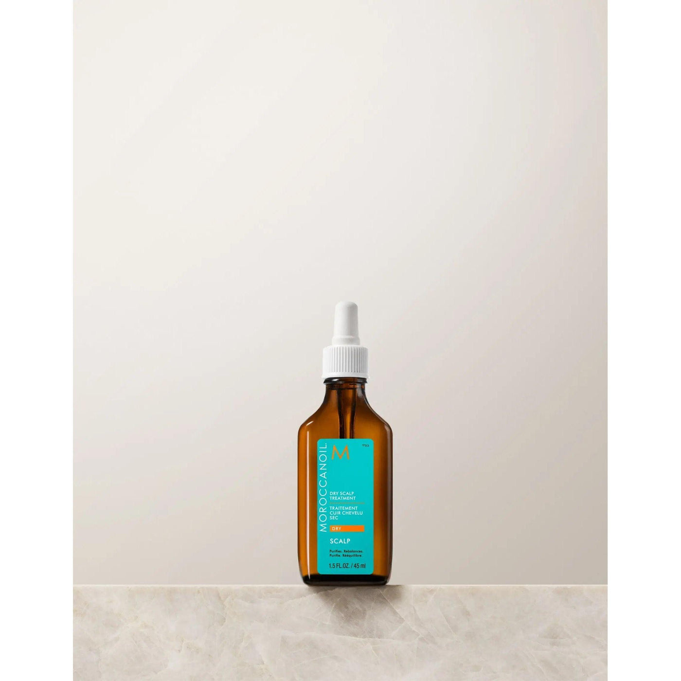 Moroccanoil Dry-No-More Scalp Treatment in amber bottle, designed to hydrate and revitalize dry scalps with natural ingredients.