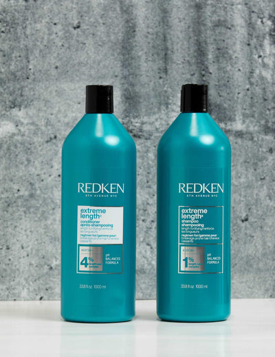 Redken Duo Liters Extreme Length Shampoo and Conditioner bottles on a textured background. Boosts hair strength and growth.