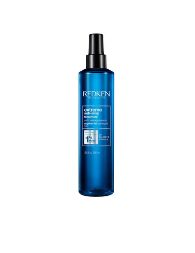 Redken Extreme Anti-Snap Treatment in a blue spray bottle, designed to strengthen and reduce hair breakage.