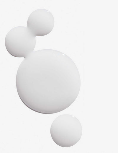 Three droplets of Redken Extreme Anti-Snap Treatment, showcasing the creamy texture ideal for damaged hair care.