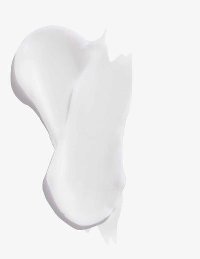 Swatches of creamy white conditioner from Redken Extreme, designed for damaged hair repair and strengthening.