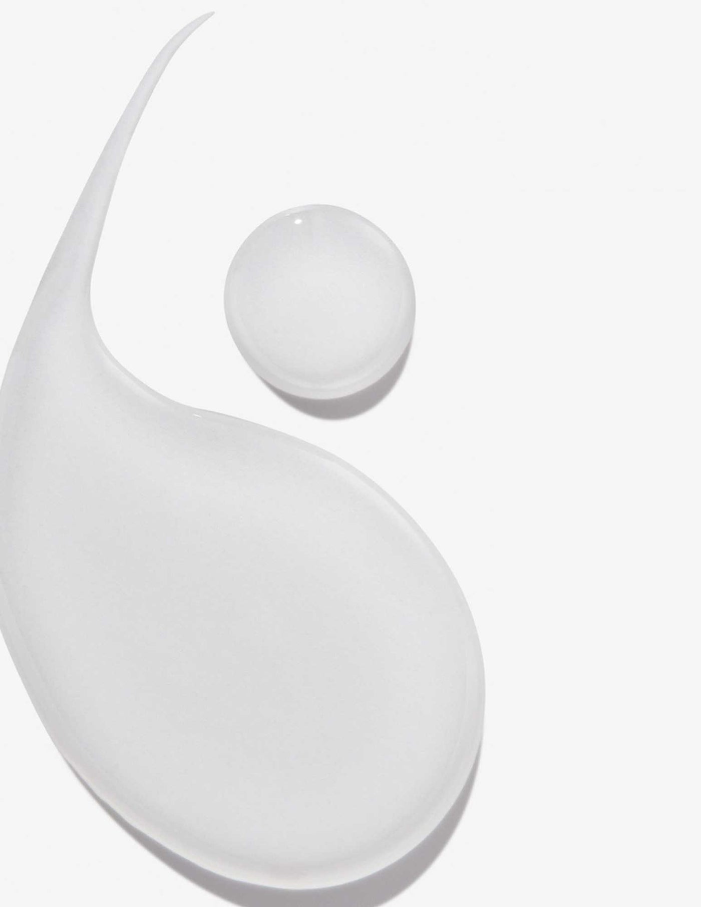 Transparent droplets of shampoo showcasing its smooth texture for healthy hair care.