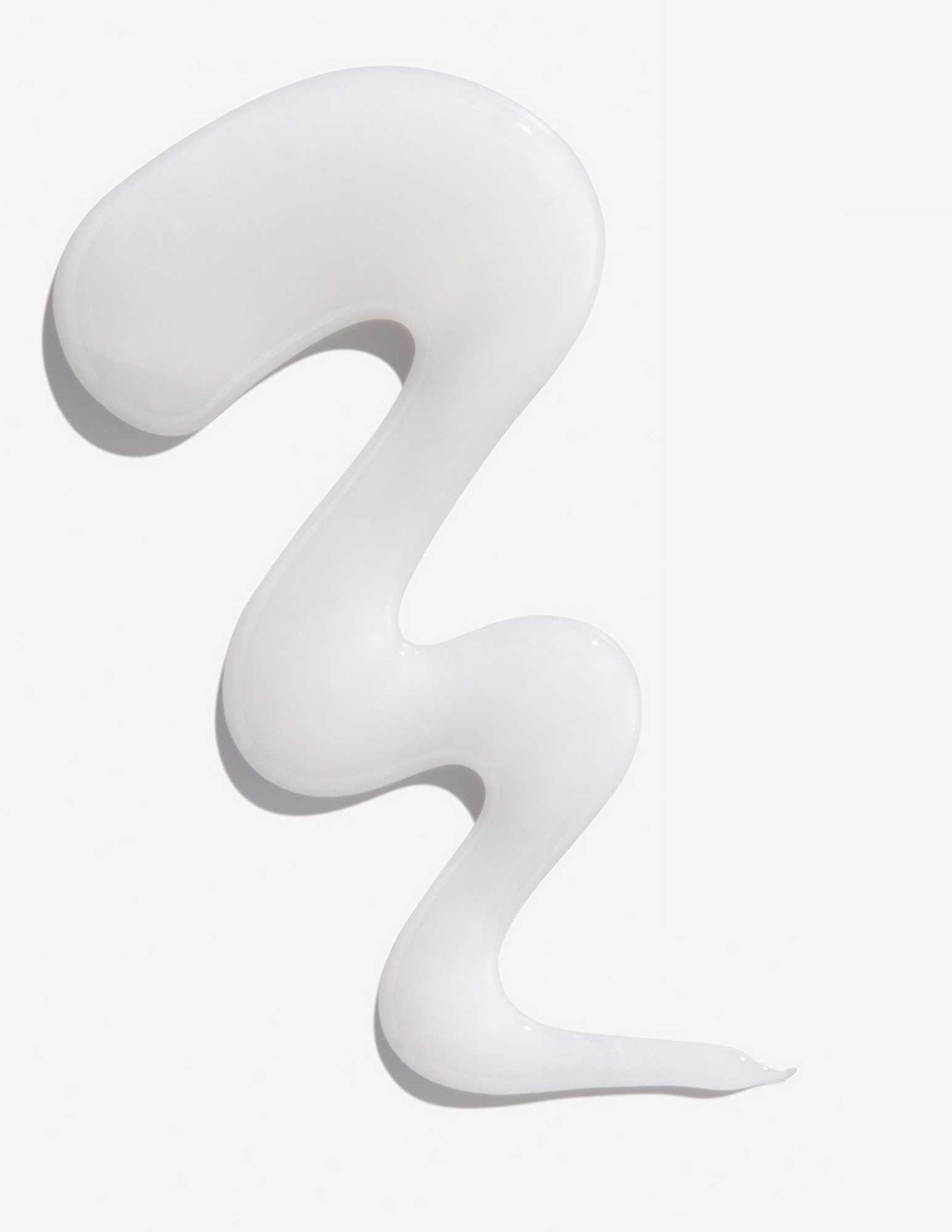 Smooth, curly swirl of white shampoo representing Redken Extreme Shampoo for damaged hair.