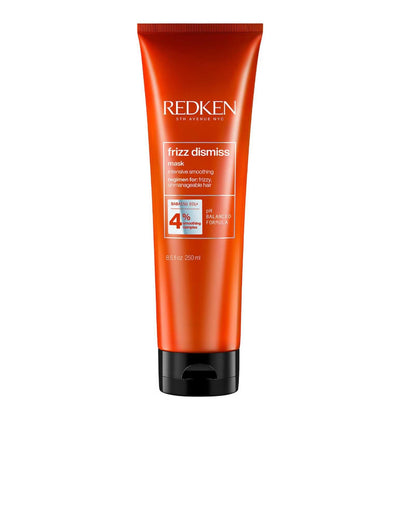 Redken Frizz Dismiss Mask in an orange tube for frizz control and hair nourishment, suitable for all hair types and textures.