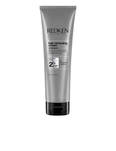 Redken Hair Cleansing Cream Shampoo in a silver tube, clarifying formula for all hair types and textures, promoting freshness.