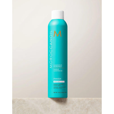 Moroccanoil Luminous Medium Finish Hairspray in turquoise canister with sleek design on a light background.