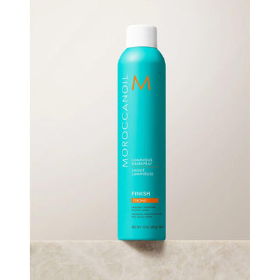 Luminous Strong Finish Hairspray by Moroccanoil in a turquoise can, designed for flexible hold and glossy finish.