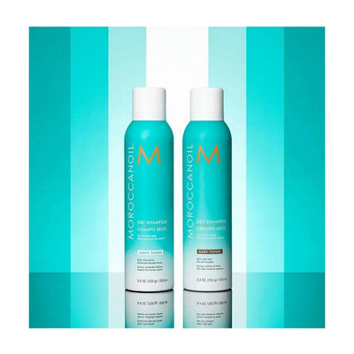 Moroccanoil Dry Shampoo Light Tones bottles against a vibrant turquoise background, showcasing odor removal and brassiness control.