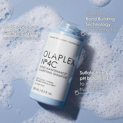 Olaplex No. 4C Bond Maintenance Clarifying Shampoo bottle in bubbles, designed for all hair types, sulfate-free for healthy hair.