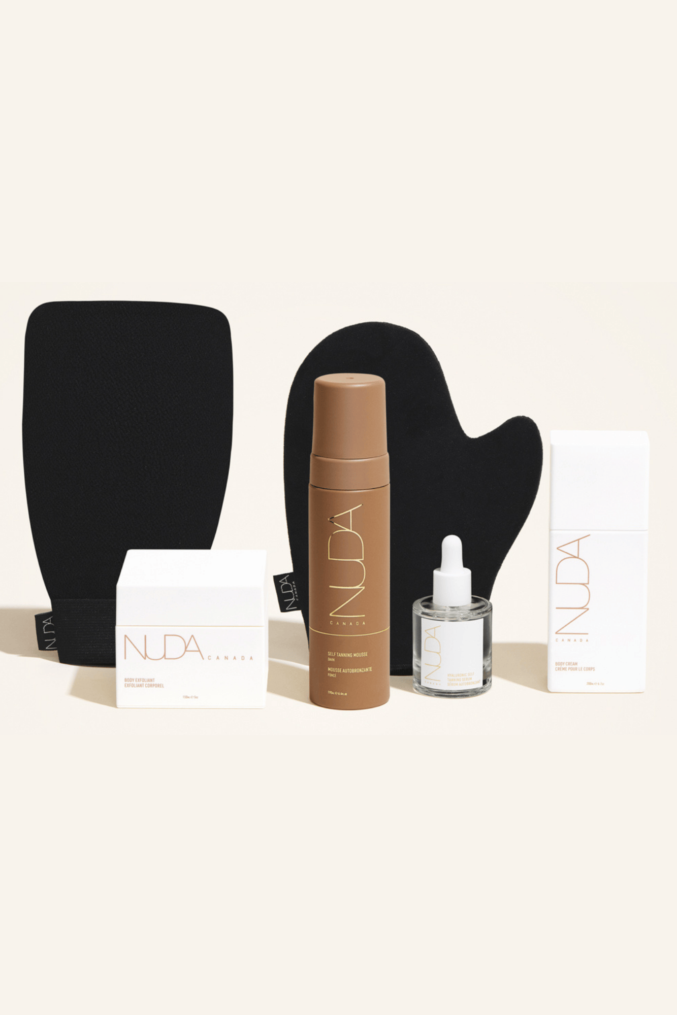 Deluxe Routine Kit featuring self-tanning mousse, exfoliating mitt, body cream, and face tanner for customizable glow.