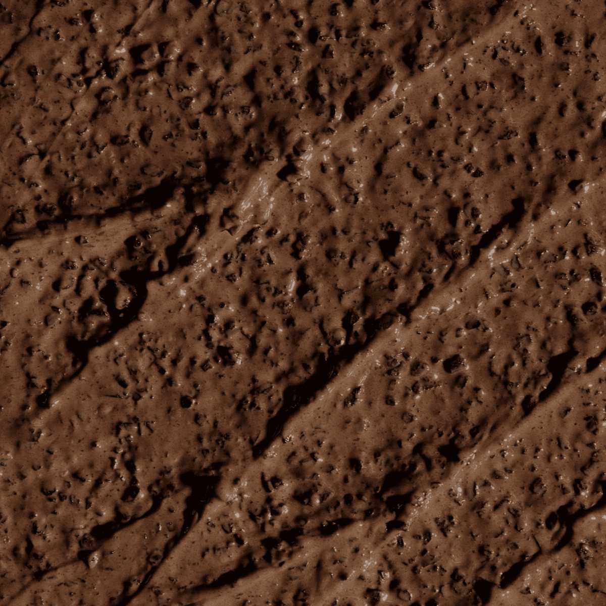 Creamy texture of a luxurious Body Exfoliant with Coffee Arabica, showcasing its rich, brown color and gentle, scrub-like appearance.