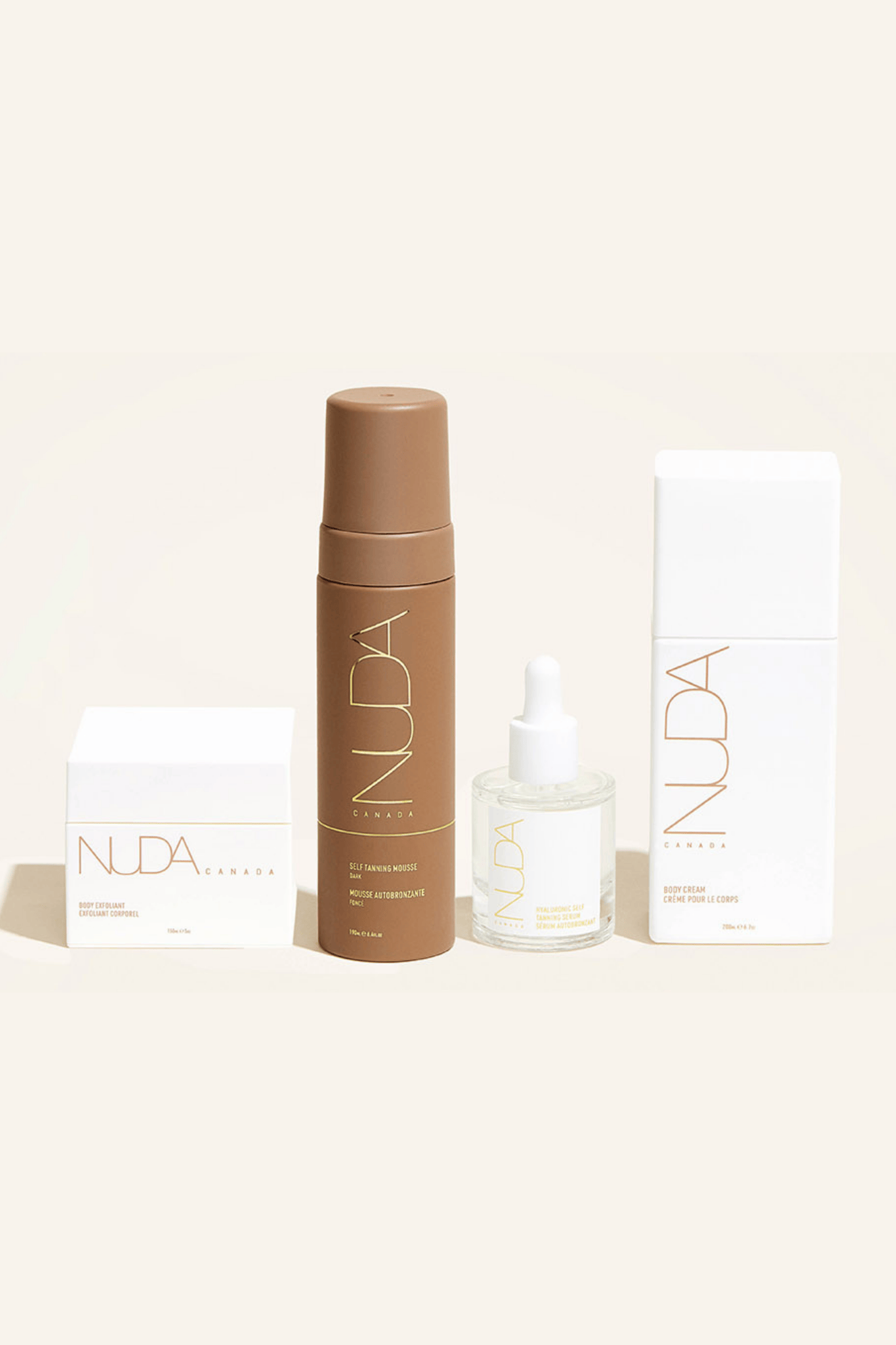 Nuda Routine Kit featuring self tanning mousse, body exfoliant, face tanner, and body cream for a perfect glow.