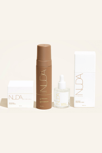 Nuda Routine Kit featuring self tanning mousse, body exfoliant, face tanner, and body cream for a perfect glow.