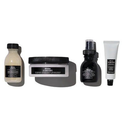 Davines Oi Travel Gift Set featuring Oi Shampoo, Oi Conditioner, Oi All-In-One Milk, and Oi Hand Balm for hair and skin care.