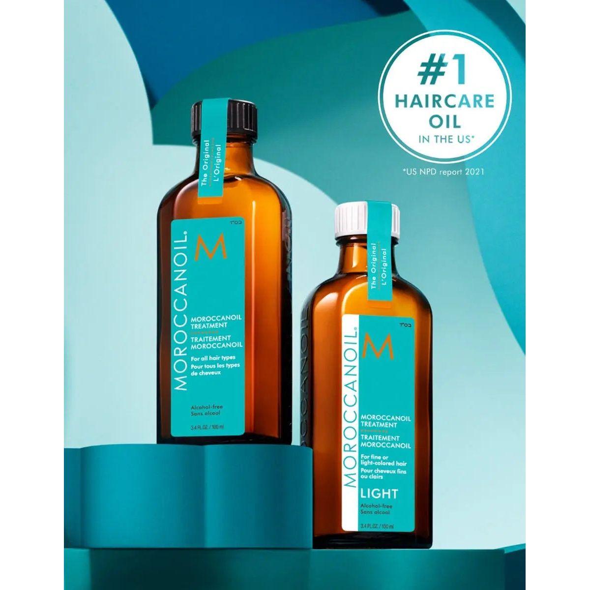 Two bottles of Moroccan Oil Original and Light Hair Treatment labeled as "#1 Haircare Oil in the US."