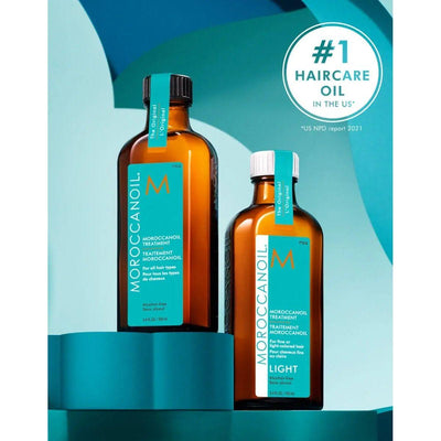 Two bottles of Moroccan Oil Original and Light Hair Treatment labeled as "#1 Haircare Oil in the US."