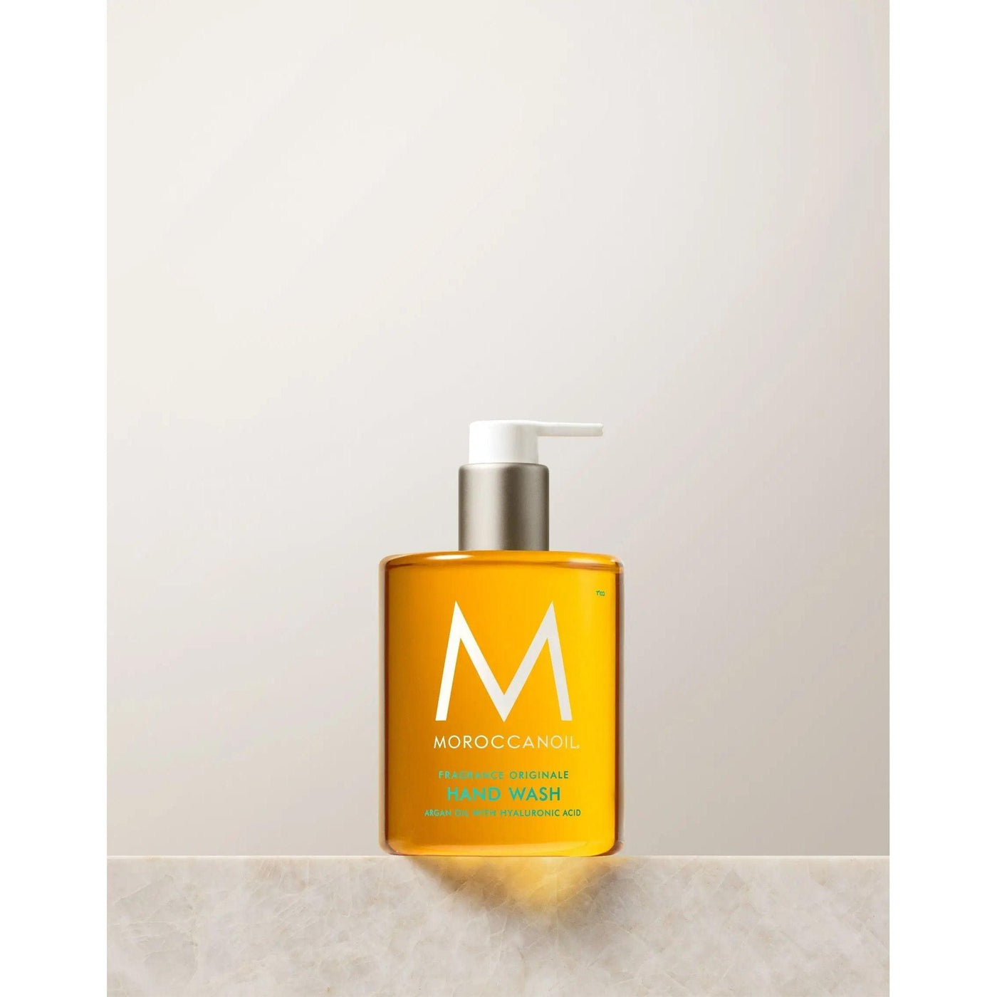Originale Fragrance Hand Wash in a clear bottle featuring a pump, enriched with argan oil and hyaluronic acid.