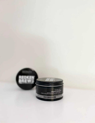Redken Brews Maneuver Cream Pomade jar on a white background, showcasing versatile hair styling for men.