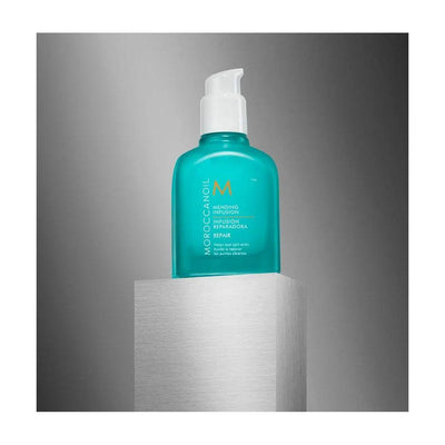 Moroccanoil Mending Infusion bottle on a pedestal, promoting hair repair and split end sealing benefits.