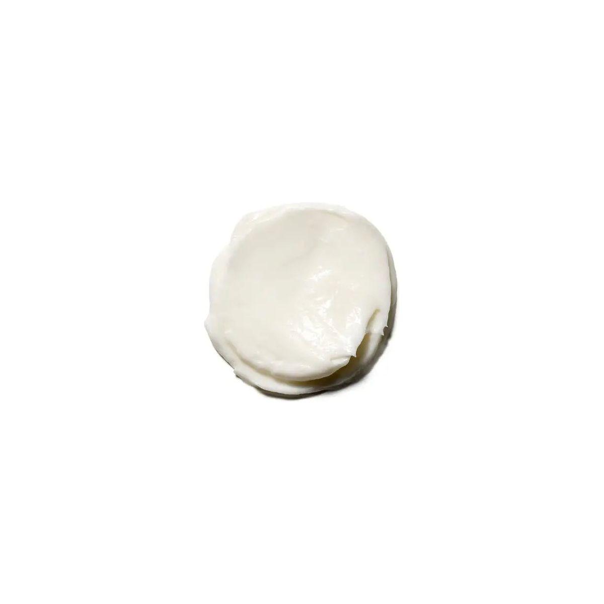 Close-up of a creamy, white restorative repair hair mask for deep nourishment and moisture.