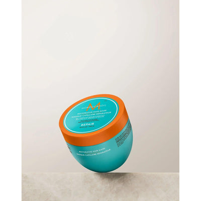 Restorative Repair Hair Mask in turquoise container with orange lid, ideal for repairing damaged and dry hair.